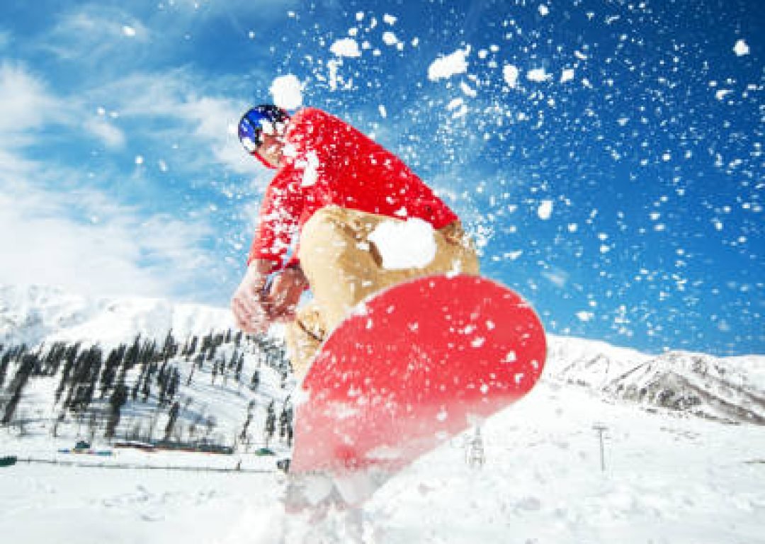 Man jumping with snowboard